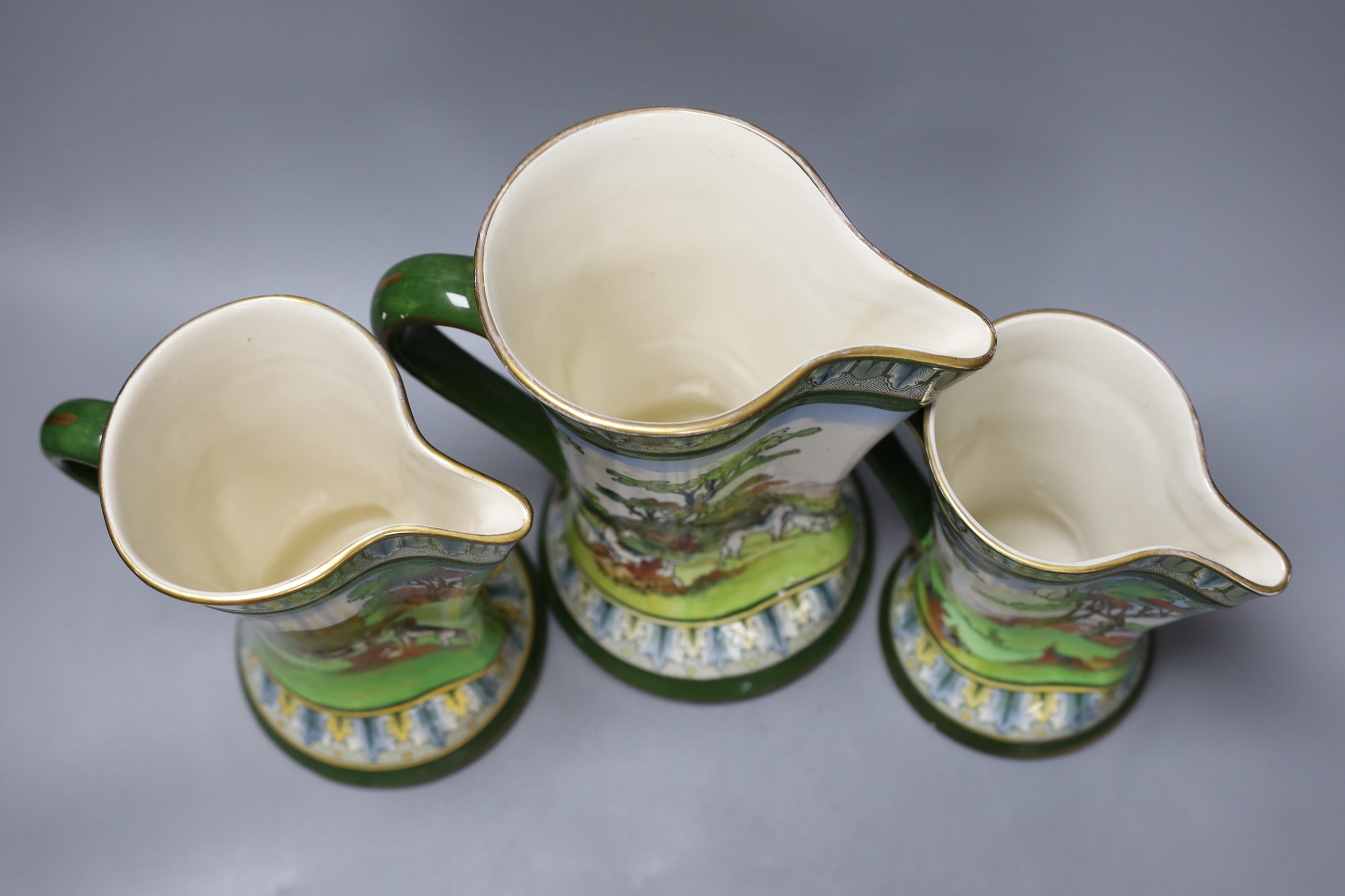 A graduated set of three Royal Doulton hunting jugs, 22cm